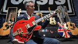 Noel's guitar, damaged when Oasis split, up for auction