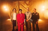 Weezer’s “C.E.O.” Video Has Curry Barker, Celeb Cameos, & A “Sweater Song” Homage