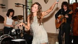Miley Cyrus takes centre stage in a fringed halterneck minidress as she performs at her star-studded...