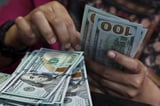 Dollar holds near three-week high before CPI data; Bitcoin hovers above $120,000