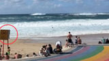 Bizarre act as huge waves hit iconic beach