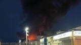 Travel chaos after massive blaze breaks out near London train station as dozens of firefighters battle inferno