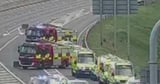 Child killed after minibus flips over on motorway with others injured
