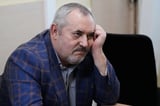 A Putin critic is convicted on charges that will keep from campaigning for Russia's parliament