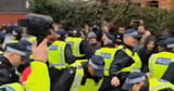 Protesters scream 'shame on you' at police in tense scenes after terror arrests