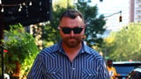 Sam Smith cuts a sombre figure and shields their eyes behind shades after paying heartbreaking tribute to One Direction choreographer Paul Roberts following his tragic death