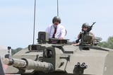 King Charles enjoys ride in British Army Challenger tank during regiment visit