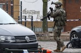 Belgian police hunt for masked gunmen after shooting outside Brussels metro