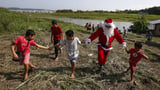 Santa braves the sticky heat of the Amazon jungle to bring gifts to children in Brazilian village