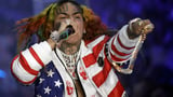 Rapper Tekashi 6ix9ine is arrested in New York for a possible parole violation