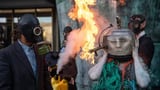 'Ocean goddess' 'drowns' in fake oil as flames engulf climate protest in London