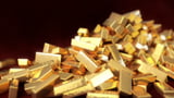 Gold hovers near record high on safe-haven demand