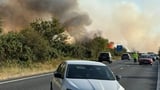 Major road shut after car bursts into flames causing standstill traffic as huge fire spreads with smoke seen for miles