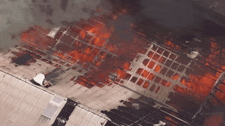 Massive Factory Fire Rages in Sydney; Firefighters Battle Blaze Amid Collapses, Public Urged to Assist Probe