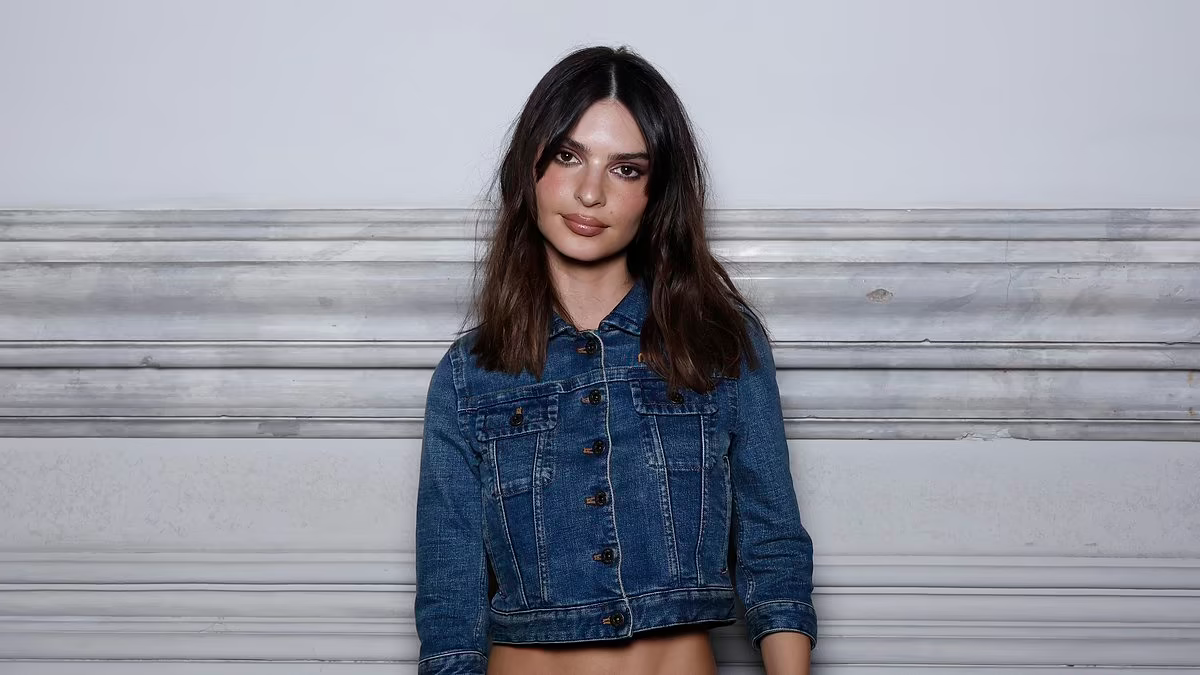 Emily Ratajkowski displays her taut midriff in denim crop top as she and leggy Emma Corrin lead the...