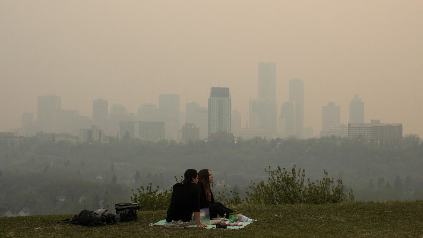 Wildfire in Canada's British Columbia forces thousands to evacuate. Winds push smoke into Alberta
