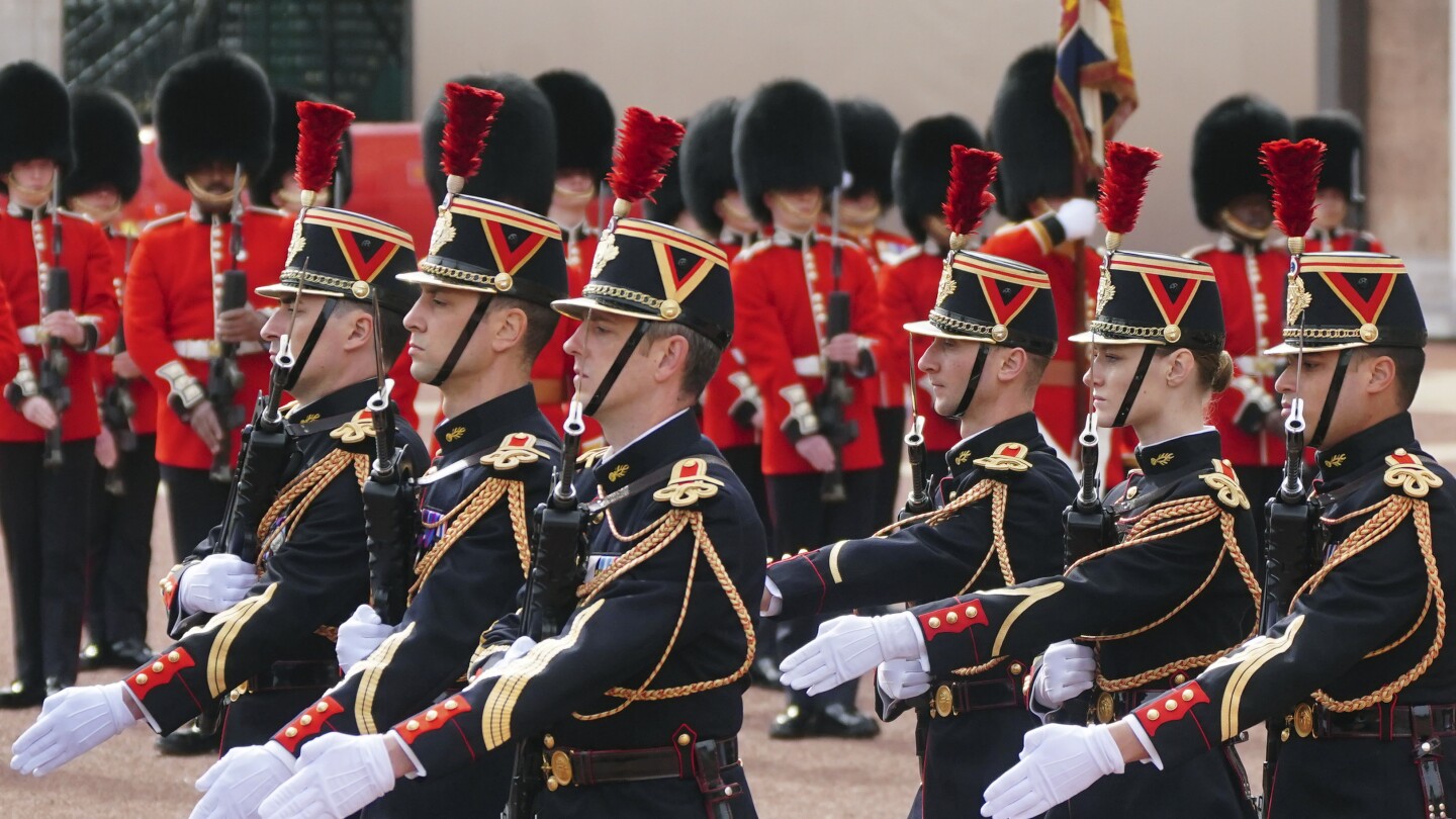 British, French troops march in historic joint parades in London and Paris in a show of solidarity